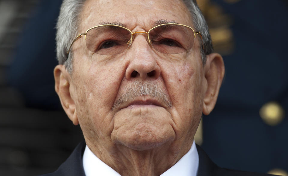 FILE - In this March 17, 2015 file photo, Cuba's President Raul Castro listens to the Cuban and Venezuelan national anthems during his welcome ceremony at the Miraflores presidential palace in Caracas, Venezuela. On Friday, April 16, 2021, Castro formally announced he'd step down as head of the Communist Party, leaving Cuba without a Castro in an official position of command for the first time in more than six decades. (AP Photo/Ariana Cubillos, File)