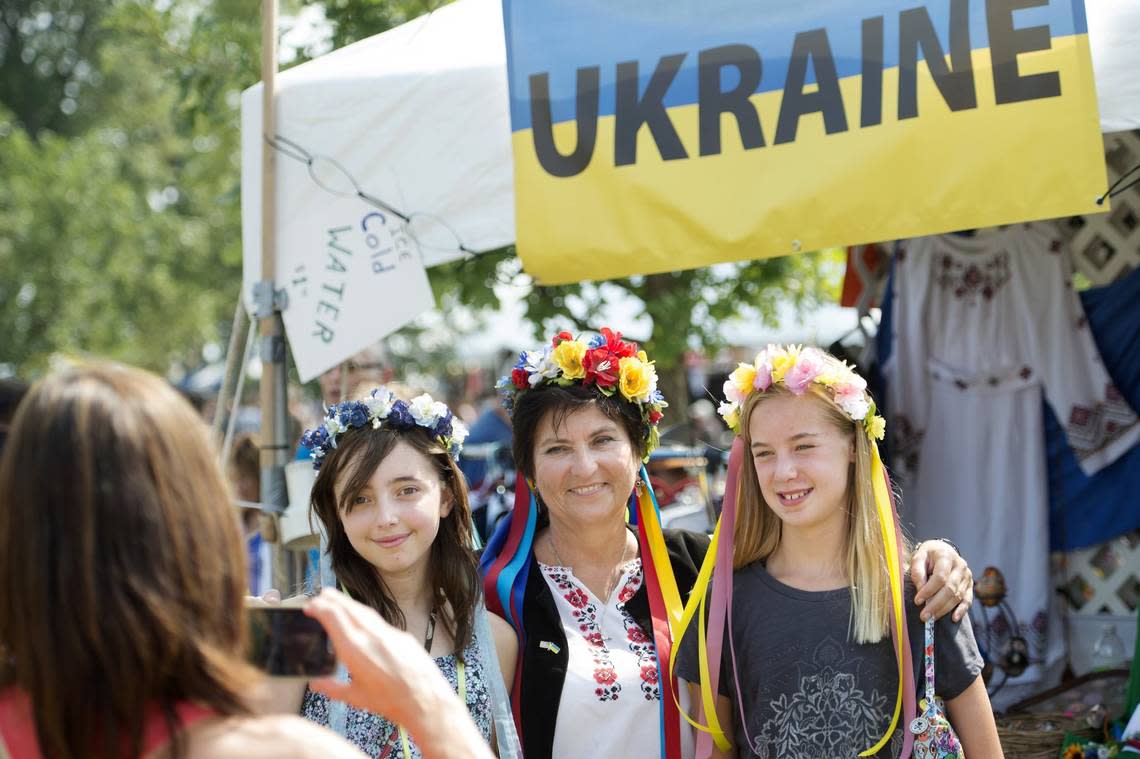 Jan Carollo of Overland Park, Kansas took pictures of her daughter, Sofie Carollo, Irene Thompson (center) and Ava Moore, during the Ethnic Enrichment festival at Swope Park in 2015. Thompson got in the photo after selling the kids a Vinok Ukraine flower head piece.