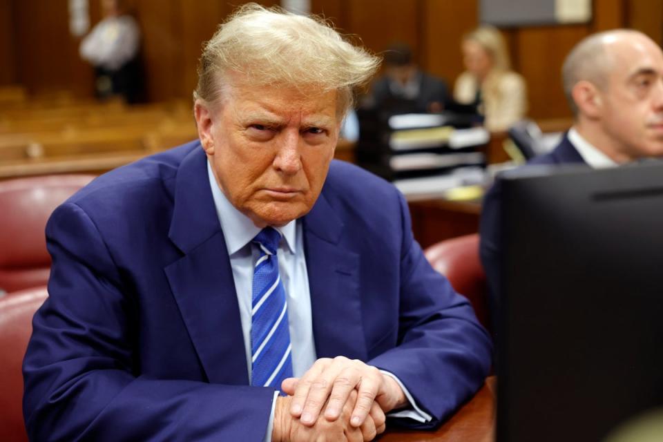 Former president Donald Trump awaits the start of proceedings on the second day of jury selection at Manhattan Criminal Court (AP)