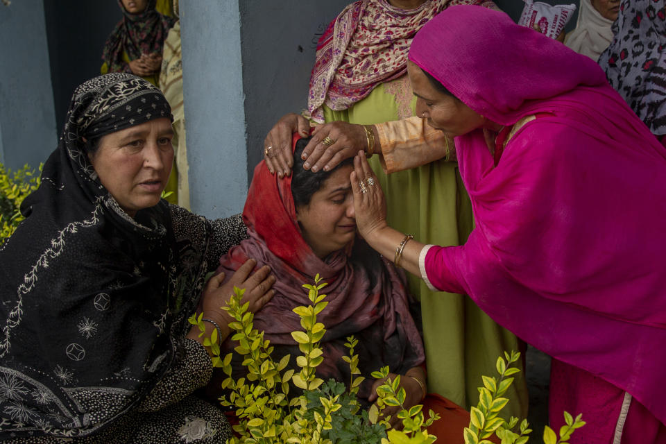 A Kashmiri villager cries beside her home that was destroyed in a gunfight after suspected rebels took refuge in it, in Pulwama, south of Srinagar, Indian controlled Kashmir, Wednesday, July 14, 2021. Three suspected rebels were killed in a gunfight in Indian-controlled Kashmir on Wednesday, officials said, as violence in the disputed region increased in recent weeks. Two residential houses were also destroyed. (AP Photo/ Dar Yasin)