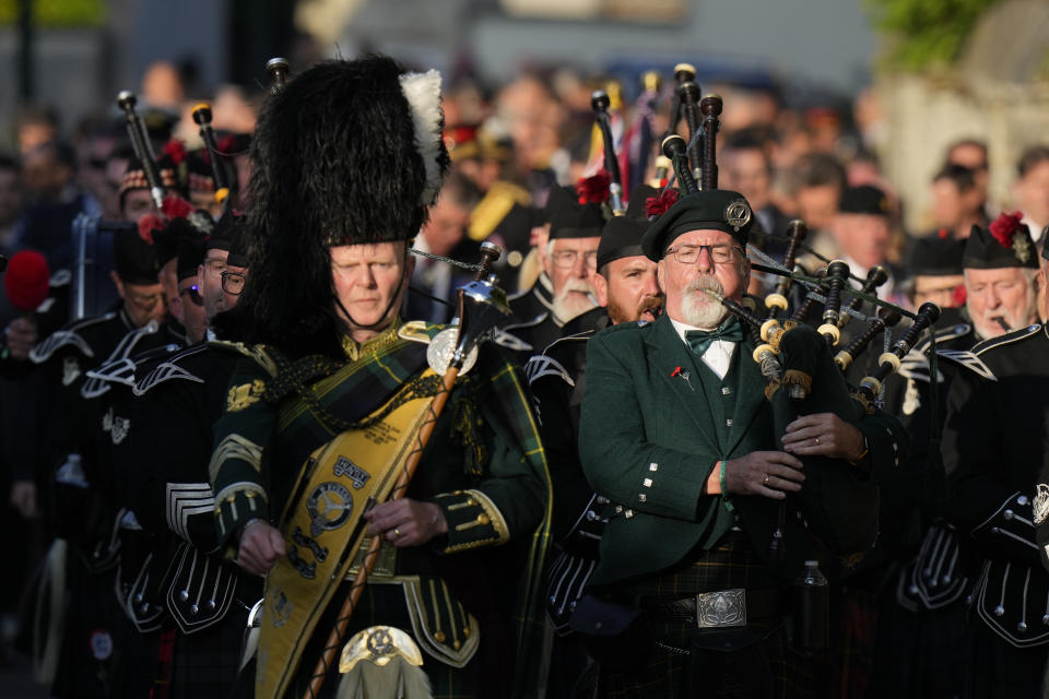 International pipers from France, Germany and the United Kingdom march during a procession from Bayeux Cathedral to the Great Vigil at the Commonwealth War Grave Commission's Bayeux War Cemetery to mark the 80th anniversary of D-Day, in Normandy, France, Wednesday June 5, 2024. (AP Photo/Alastair Grant)