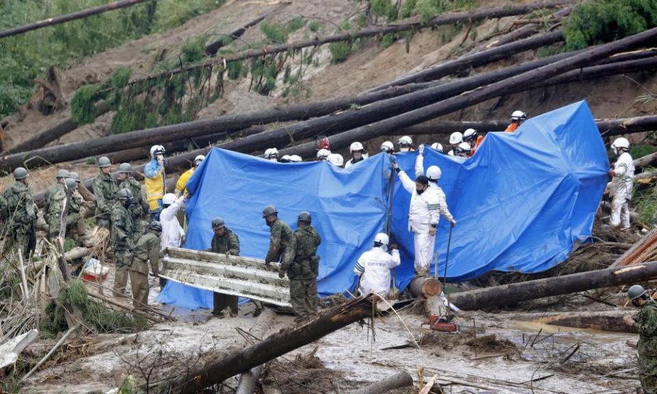 Rescuers search for survivors at the site of a landslide in Miyazaki prefecture, southern Japan, after Typhoon Nanmadol brought heavy winds and rain.