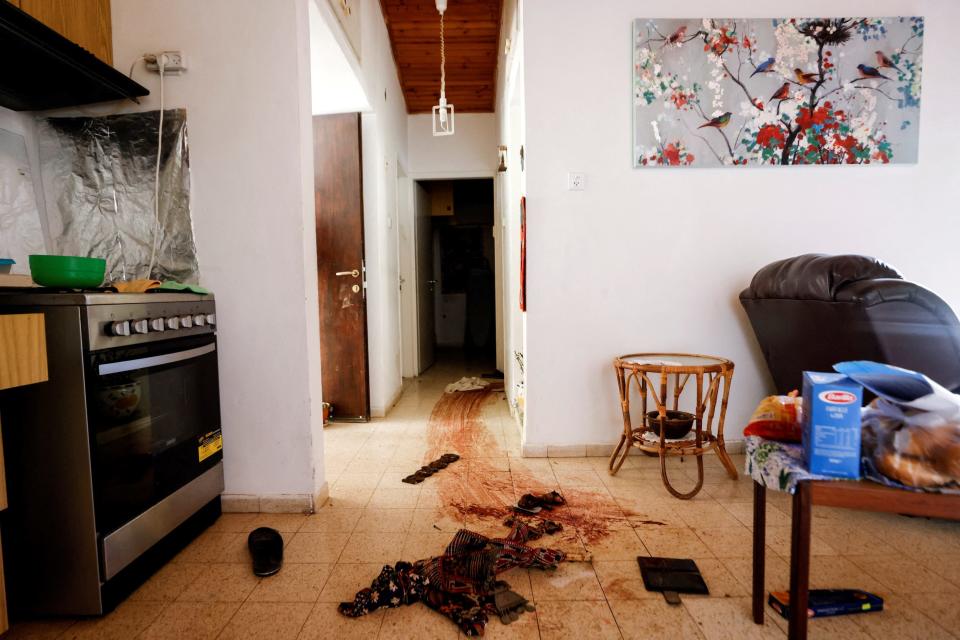 A graphic image of a drag mark of dried blood leading from the kitchen in a home to a separate room.