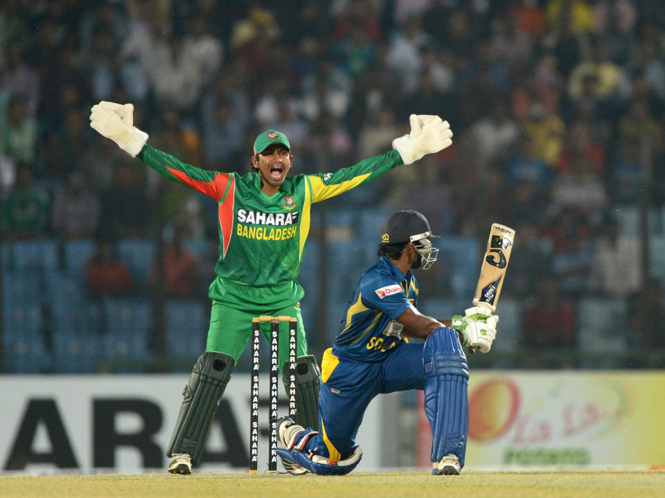 Bangladesh wicketkeeper Anamul Haque (L) makes asuccessful appeal for the wicket of Sri Lankan batsman Kusal Perera (R) during the second T20 cricket match between Bangladesh and Sri Lanka at The Zahur Ahmed Chowdhury Stadium in Chittagong on February 14, 2014. AFP PHOTO/ Munir uz ZAMAN