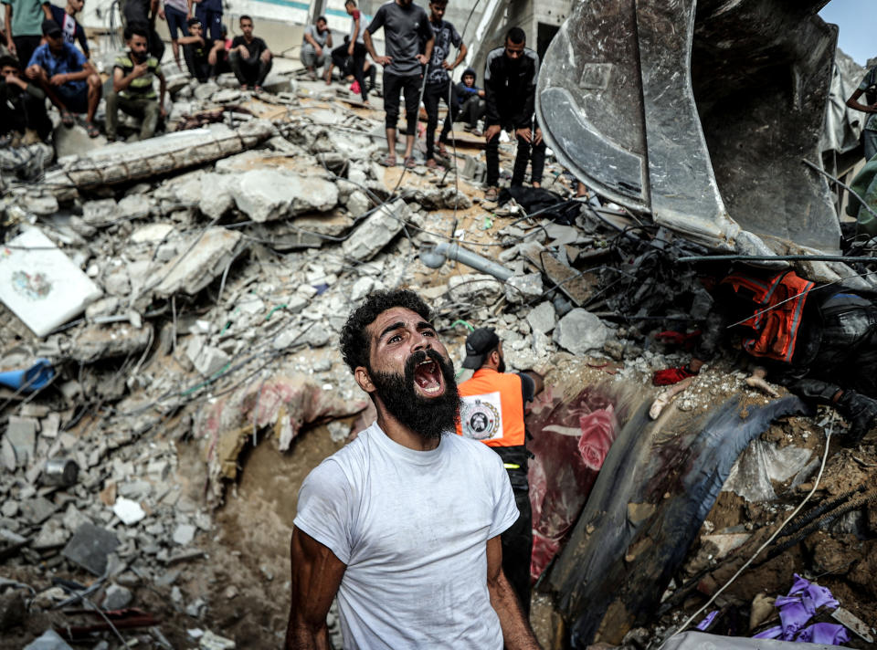 A man yells during a search for survivors following an Israeli airstrike in Gaza City.