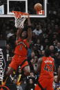 Toronto Raptors forward O.G. Anunoby hangs from the basket as he watches his shot bounce off the rim during the first half of an NBA basketball game against the Los Angeles Lakers on Wednesday, Dec. 7, 2022, in Toronto. (Chris Young/The Canadian Press via AP)