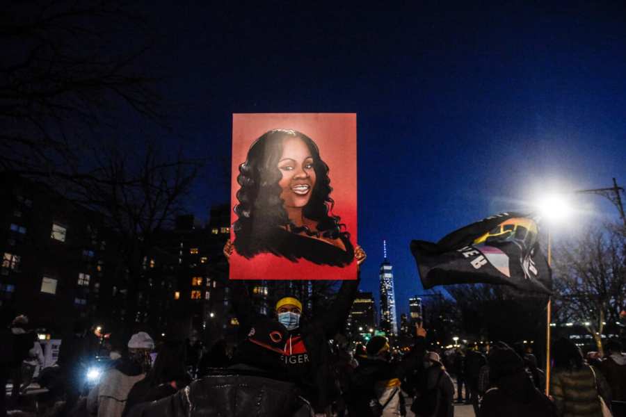 Breonna Taylor’s image is held aloft in March 2021 during a demonstration in New York marking the one-year anniversary of her killing by police in Louisville, Kentucky. Three officers are accused of lying to obtain the warrant used to raid her residence. (Credit: Stephanie Keith/Getty Images).