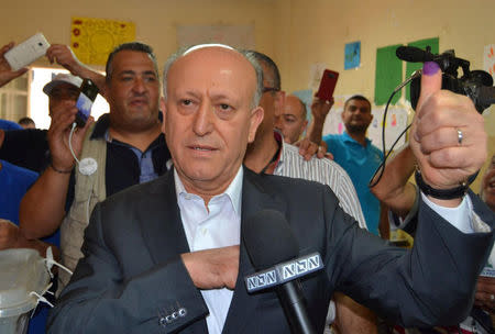 Sunni politician Ashraf Rifi shows his ink-stained finger after casting his ballot at a polling station during Tripoli's municipal elections, Lebanon, May 29, 2016. REUTERS/Stringer