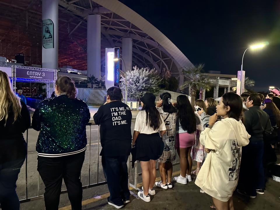 A family, including their dad, stand outside SoFi Stadium in Inglewood, Calif. on Aug. 11, 2023 listening to a Taylor Swift concert. His T-shirt is a reference to Swift’s song, “Anti-Hero,” she released in October 2022. | Sarah Gambles, Deseret News