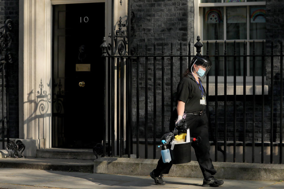 LONDON, April 16, 2020 .A cleaner wearing face mask leaves 10 Downing Street in London, Britain, on April 16, 2020. The British government announced on Thursday that the current restrictive measures that aim to contain the spread of the novel coronavirus will remain in place for "at least three weeks".  As of Thursday morning, 103,093 people in Britain tested positive for COVID-19, said the Department of Health and Social Care. (Photo by Tim Ireland/Xinhua) (Xinhua/ via Getty Images)