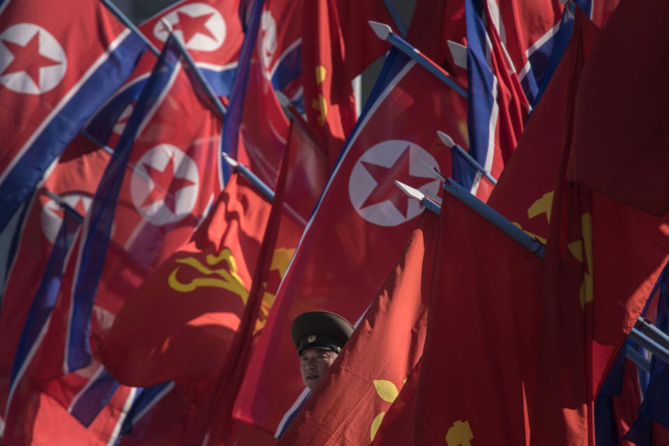 A Korean People’s Army soldier stands between flags in Pyongyang on April 13, 2017. (Photo: Ed Jones/AFP/Getty Images)
