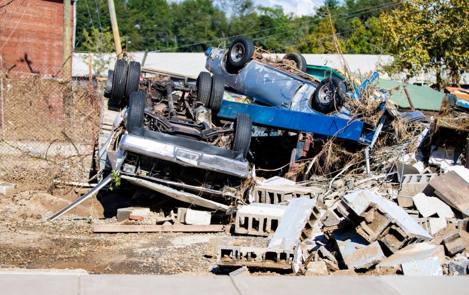 Cars sit piled on top of one another in the River Arts District in Asheville Wednesday afternoon.