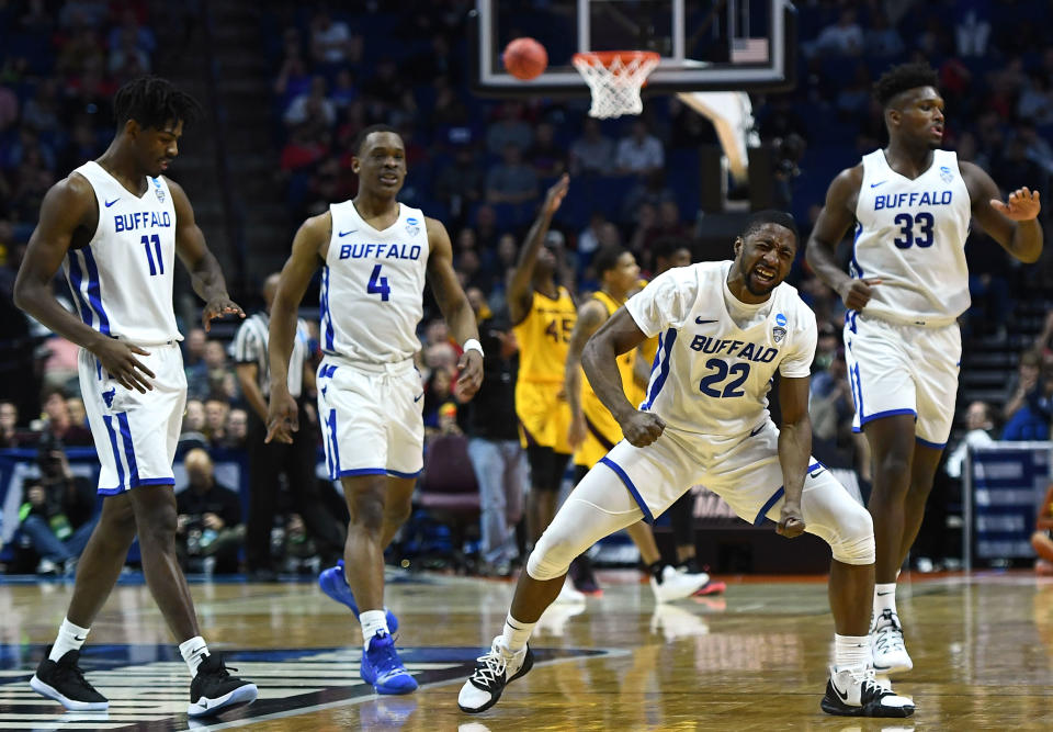 <p>Dontay Caruthers #22 of the Buffalo Bulls celebrates around teammates Jeenathan Williams #11, Davonta Jordan #4, and Nick Perkins #33 during the first half of the first round game of the 2019 NCAA Men’s Basketball Tournament against the Arizona State Sun Devils at BOK Center on March 22, 2019 in Tulsa, Oklahoma. </p>