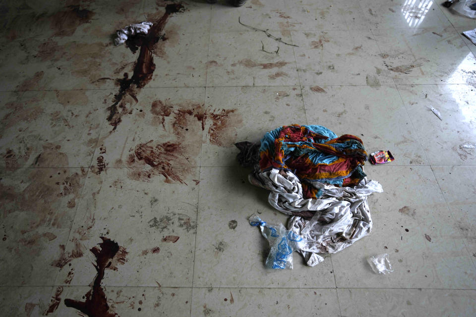Clothes of passengers who were traveling in the train that derailed are seen lying on the blood soaked floor in a school where bodies were kept, in Balasore district, in the eastern Indian state of Orissa, Sunday, June 4, 2023. Indian authorities end rescue work and begin clearing mangled wreckage of two passenger trains that derailed in eastern India, killing over 300 people and injuring hundreds in one of the country’s deadliest rail crashes in decades. (AP Photo/Rafiq Maqbool)