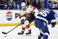 Florida Panthers defenseman Brandon Montour (62) works against Tampa Bay Lightning defenseman Maxwell Crozier (65) during the first period in Game 4 of an NHL hockey Stanley Cup first-round playoff series, Saturday, April 27, 2024, in Tampa, Fla. (AP Photo/Chris O'Meara)