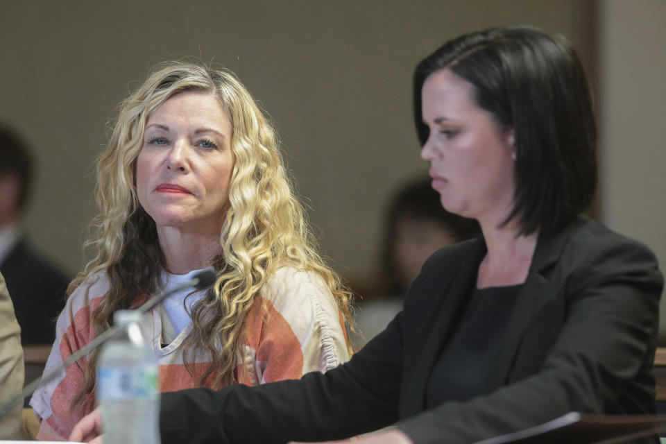 FILE - In this March 6, 2020, file photo, Lori Vallow Daybell glances at the camera during her hearing in Rexburg, Idaho. At her right is defense attorney Edwina Elcox. The Idaho attorney general has agreed to investigate the mother of two missing children and her husband in connection with the death of his first wife. Daybell is being held in an Idaho jail awaiting trial on charges that she abandoned her two kids, 17-year-old Tylee Ryan and 7-year-old Joshua “JJ” Vallow. The kids disappeared in September. (John Roark/The Idaho Post-Register via AP, Pool, File)