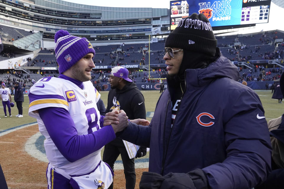 Minnesota Vikings quarterback Kirk Cousins greets Chicago Bears quarterback Justin Fields, right, after an NFL football game, Sunday, Jan. 8, 2023, in Chicago. The Vikings won 29-13. (AP Photo/Charles Rex Arbogast)