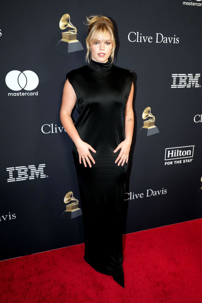 Person in sleeveless black gown with high neckline at Clive Davis Grammy event