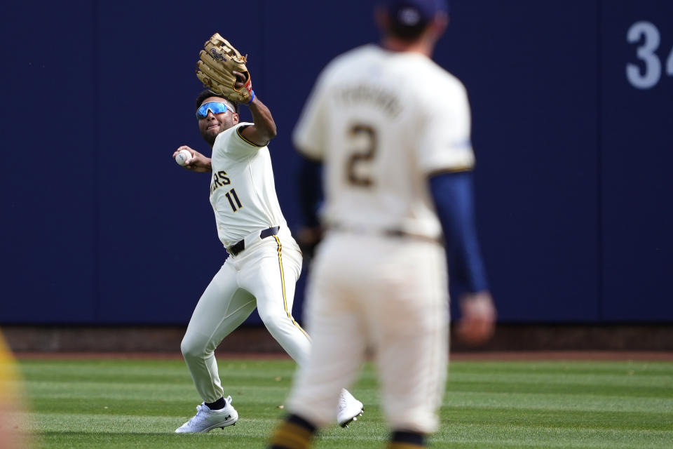 Milwaukee Brewers' Jackson Chourio throws home to stop a run after fielding a fly out hit by Los Angeles Angels' Zach Neto during the second inning of a spring training baseball game, Monday, March 18, 2024, in Phoenix. (AP Photo/Matt York)