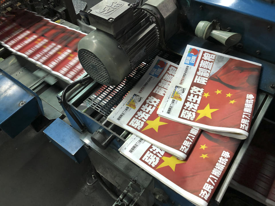 Copies of Apple Daily's July 1, 2020, edition are seen with its front page title of "Draconian law is effective, one country two system is dead" at the newspaper's printing house in Hong Kong, Wednesday, July 1, 2020. Lai said in an interview Wednesday that Hong Kong is dead under the new national security law. Lai, who owns popular newspaper Apple Daily, is a prominent advocate for democracy in Hong Kong. (AP Photo/Vincent Yu)