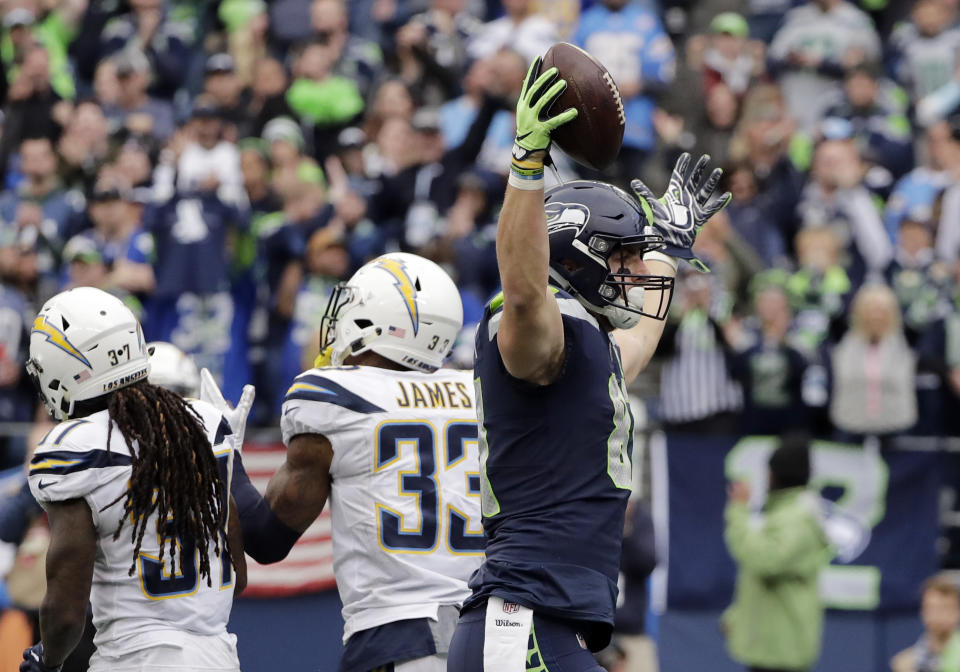 Seattle Seahawks' Nick Vannett, right, celebrates his touchdown against the Los Angeles Chargers during the second half of an NFL football game, Sunday, Nov. 4, 2018, in Seattle. (AP Photo/Ted S. Warren)
