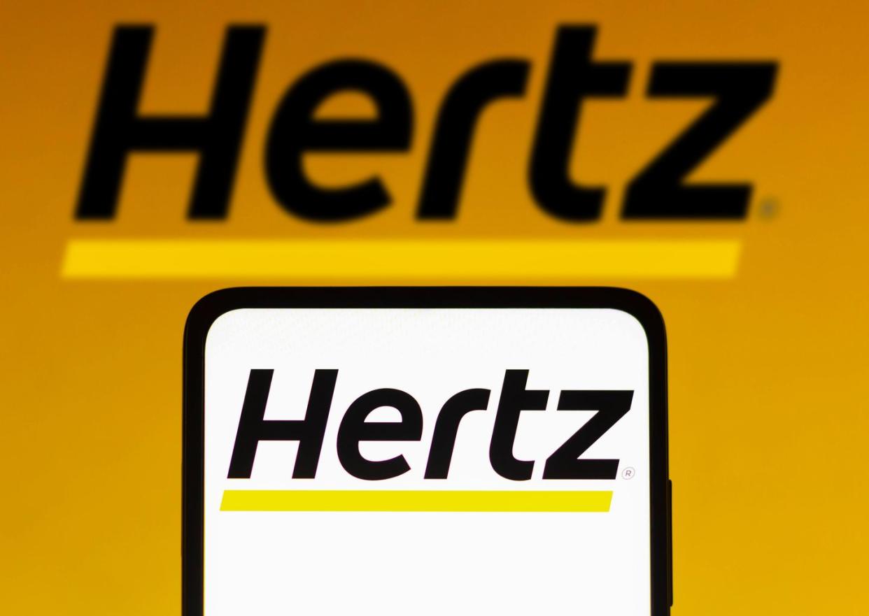 in this photo illustration, the hertz corporation logo is