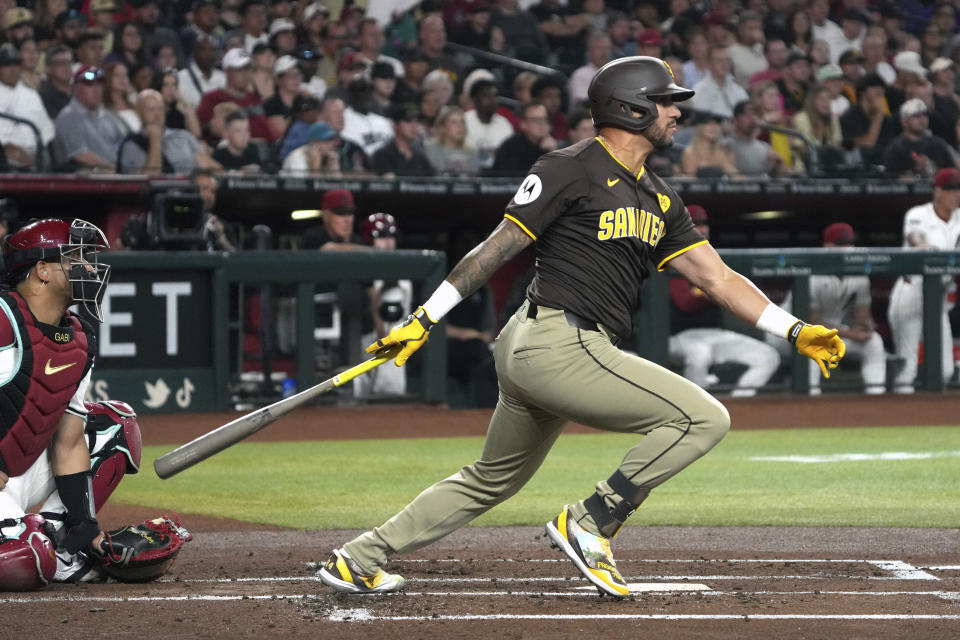 San Diego Padres' David Peralta hits an RBI single against the Arizona Diamondbacks in the first inning during a baseball game, Friday, Sept. 27, 2024, in Phoenix. (AP Photo/Rick Scuteri)