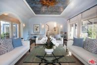 <p>The living room boasts french doors, archways and artwork on the ceiling. (Realtor.com) </p>