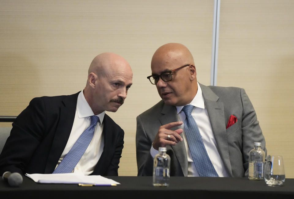 Norwegian diplomat Dag Nylander, left, and President of the National Assembly of Venezuela, Jorge Rodriguez, confer during a signing ceremony for an agreement to create a U.N.-managed fund to finance health, food and education programs for the poor during a ceremony at a hotel in Mexico City, Saturday, Nov. 26, 2022. The agreement signed by representatives of Venezuelan President Nicolás Maduro and the opposition marked the resumption of long-stalled negotiations meant to find a common path out of their country's complex crisis. The U.S. government, in response, agreed to allow oil giant Chevron to pump Venezuelan oil. (AP Photo/Fernando Llano)