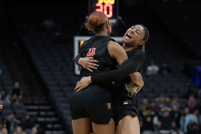 Etiwanda's Kennedy Smith (11) embraces teammate Jada Sanders (4) after Sander made the winning shot, beating Archbishop Mitty in the 4th quarter of the Open Division Girls State Championship basketball game at the Golden 1 Center in Sacramento, Calif., Saturday, March 11, 2023. Etiwanda won 69-67. (Photo/Jose Luis Villegas)