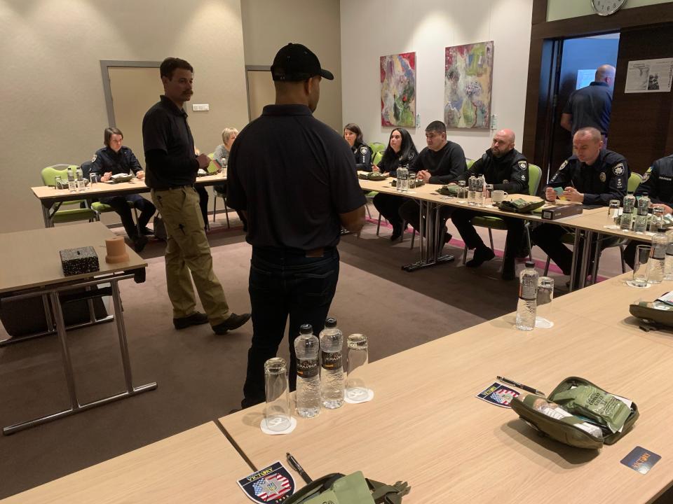 Ross Marsh (left) teaches officers of National Police of Ukraine how to properly apply first aid.