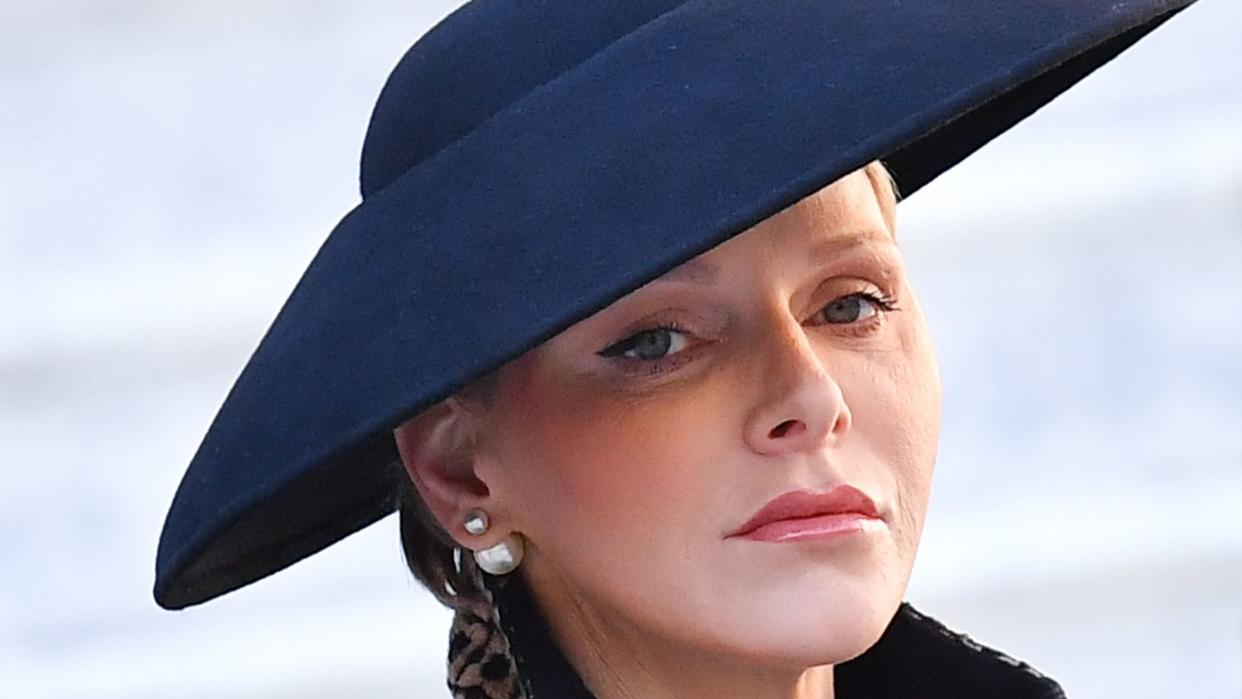 Princess Charlene in black hat