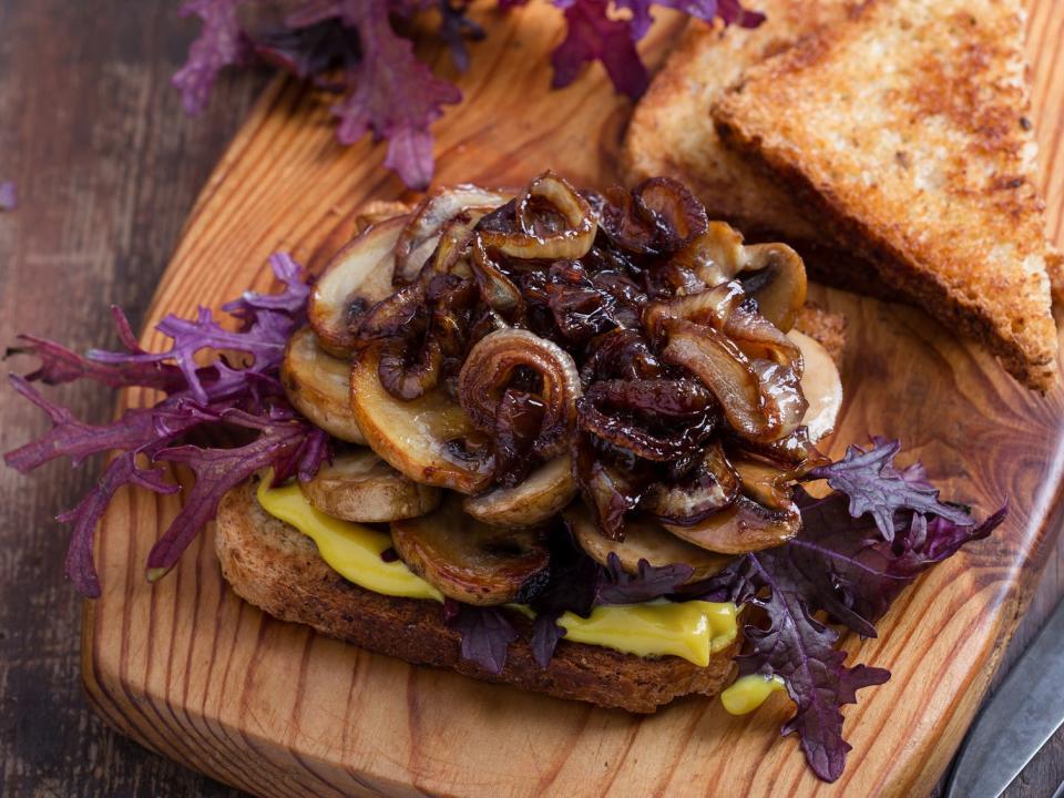 Mushroom and onion sandwich on a board.