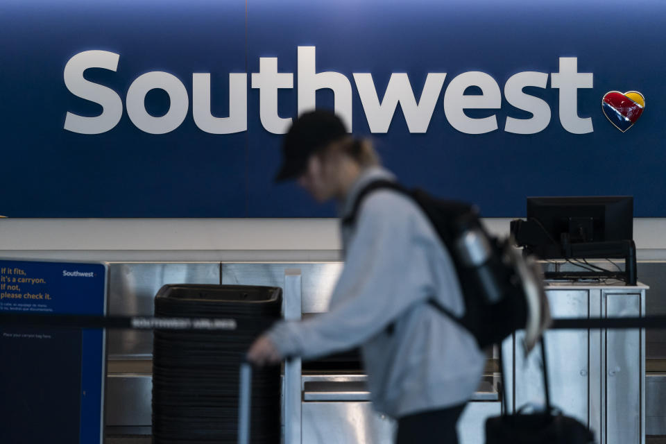 FILE - A traveler walks through the Southwest ticketing counter area at the Los Angeles International Airport in Los Angeles, April 18, 2023. Federal officials said Thursday, April 4, 2024, that they are investigating a Southwest Airlines flight that veered off course and flew close to the air traffic control tower at LaGuardia Airport last month. (AP Photo/Jae C. Hong, File)