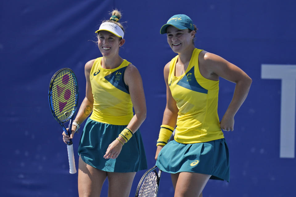 The Australian doubles team of Ashleigh Barty, right, and Storm Sanders talk during the quarterfinals of the tennis competition at the 2020 Summer Olympics, Wednesday, July 28, 2021, in Tokyo, Japan. (AP Photo/Seth Wenig)