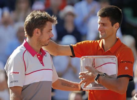 Novak Djokovic of Serbia (R) congratulates Stan Wawrinka of Switzerland during the trophy ceremony after being defeated in their men's singles final match at the French Open tennis tournament at the Roland Garros stadium in Paris, France, June 7, 2015. REUTERS/Vincent Kessler TPX IMAGES OF THE DAY