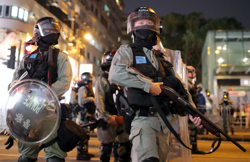 Riot police officers patrol after the "Lest We Forget" rally in Hong Kong