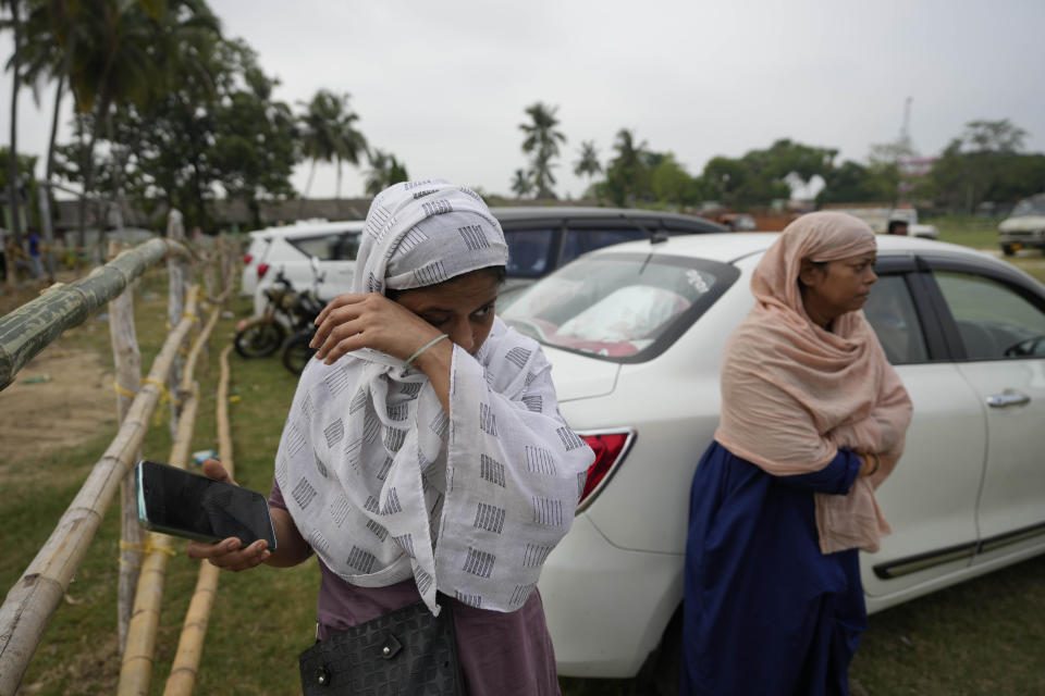 Amina, cries while showing photo of her relative Mohammed Mazar who was traveling in the train that derailed while looking for him at the site of the accident, in Balasore district, in the eastern Indian state of Orissa, Sunday, June 4, 2023. Indian authorities end rescue work and begin clearing mangled wreckage of two passenger trains that derailed in eastern India, killing over 300 people and injuring hundreds in one of the country’s deadliest rail crashes in decades. (AP Photo/Rafiq Maqbool)