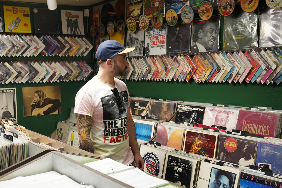 Jeff Maimon, of Chicago, checks out some vinyl at Tracks In Wax record shop, Thursday, April 18, 2024, in Phoenix. Special LP releases, live performances and at least one giant block party are scheduled around the U.S. Saturday as hundreds of shops celebrate Record Store Day amid a surge of interest in vinyl and the day after the release of Taylor Swift's latest album. (AP Photo/Ross D. Franklin)