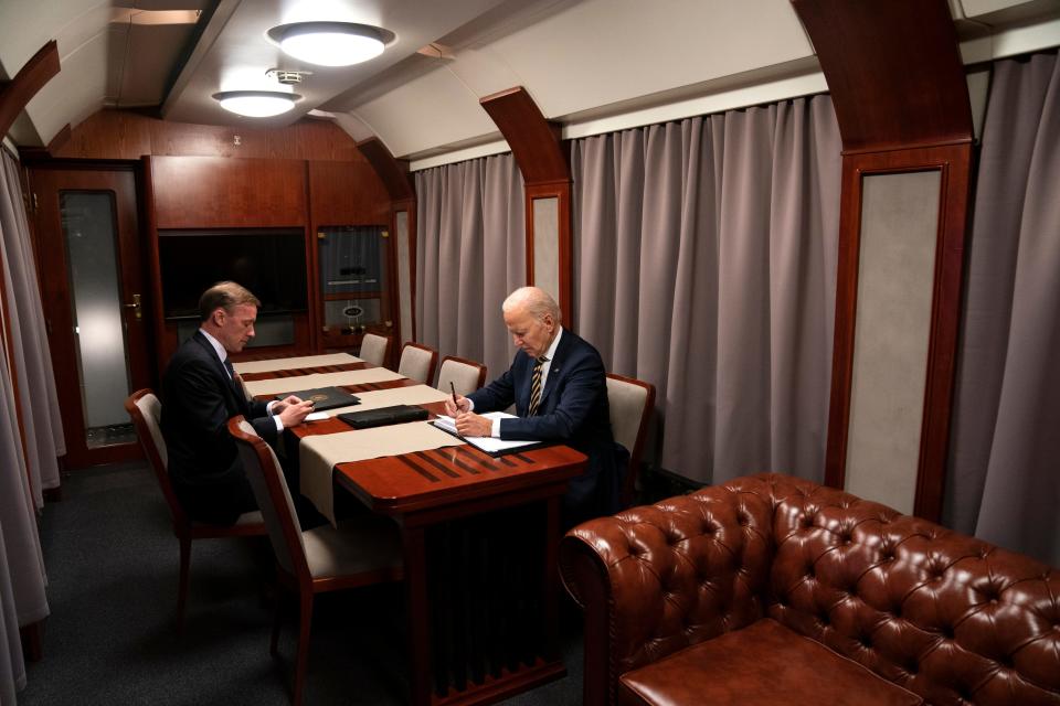 President Joe Biden sits on a train with National Security Advisor Jake Sullivan as he goes over his speech marking the one-year anniversary of the war in Ukraine after a surprise visit with Ukrainian President Volodymyr Zelenskyy, Monday, Feb. 20, 2023, in Kyiv. (AP Photo/ Evan Vucci, Pool) ORG XMIT: UAEV180