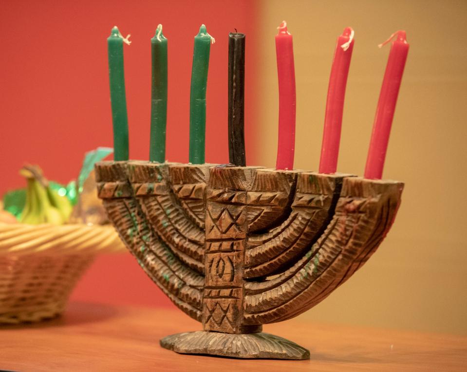 Candles in a kinara, which will be lit over several days in celebration of the start of the first day of Kwanzaa, a seven day event that connects Black Americans with African heritage Dec. 26, 2019. Indianapolis Public Library main branch.