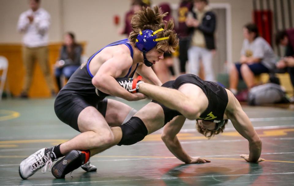 Jefferson's John Allen (left) tries to control Nicholas Sikorski of Flat Rock Wednesday night in a Huron League quad at St. Mary Catholic Central.