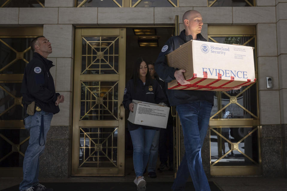 Federal agents carry evidence boxes as they walk out of a Park Avenue high-rise on Thursday, Sep. 1, 2022, in New York. FBI agents and Homeland Security Investigations personnel searched properties linked to Viktor Vekselberg, a close ally of Russian President Vladimir Putin. U.S. federal agents on Thursday simultaneously searched properties in Manhattan, the posh beach community of Southampton, N.Y., and on an exclusive Miami island that have been linked to the billionaire Russian oligarch whose $120 million yacht was seized in April. (AP Photo/Yuki Iwamura)
