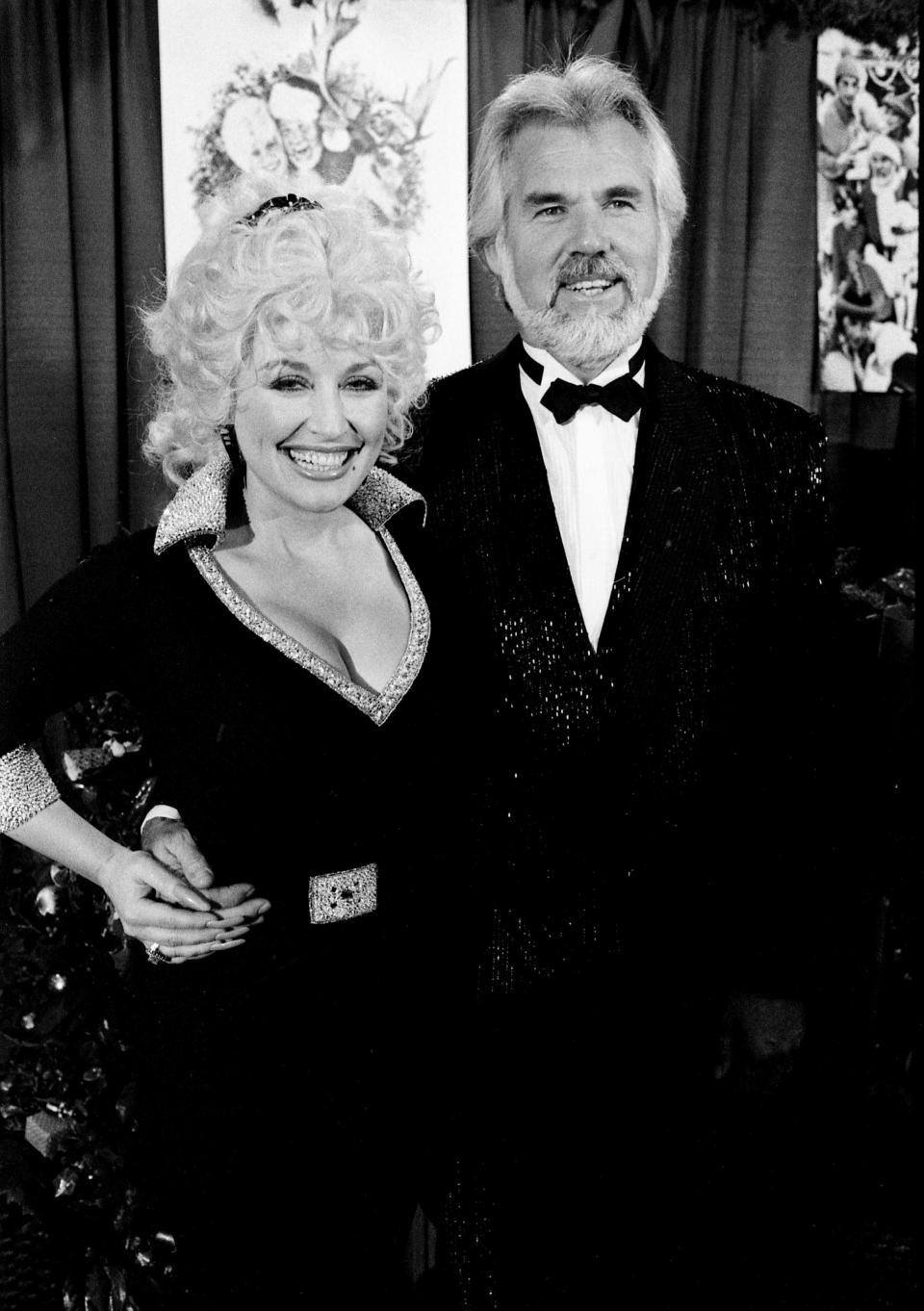 Superstars Dolly Parton and Kenny Rogers are all smiles Oct. 8, 1984, as they discuss plans for an upcoming Christmas television special, the release of a duet Christmas album and a joint tour to begin New Year's Eve. They held the news conference immediately after the CMA Awards show at the Opryland Hotel.