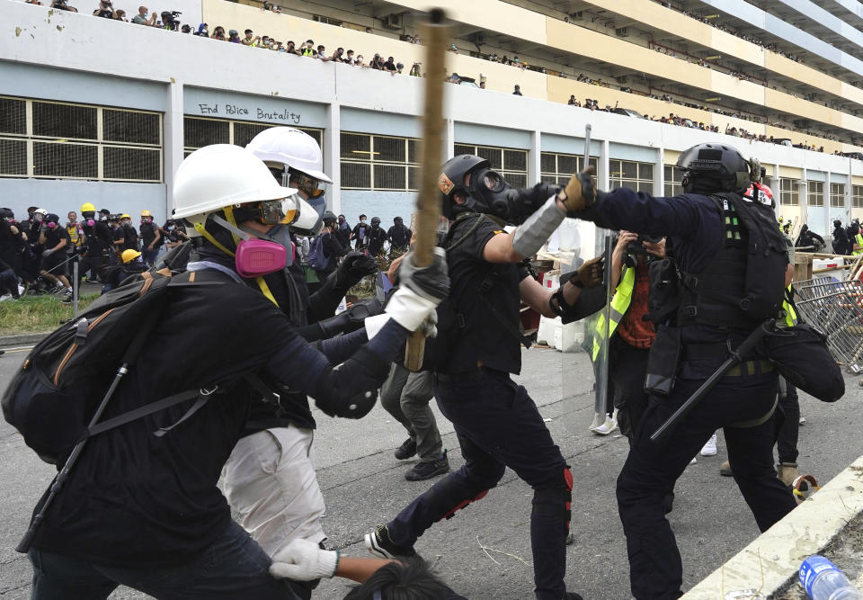 Police and demonstrators clash during a protest in Hong Kong, Saturday, Aug. 24, 2019. Chinese police said Saturday they released an employee at the British Consulate in Hong Kong as the city's pro-democracy protesters took to the streets again, this time to call for the removal of "smart lampposts" that raised fears of stepped-up surveillance. (AP Photo/Vincent Yu)