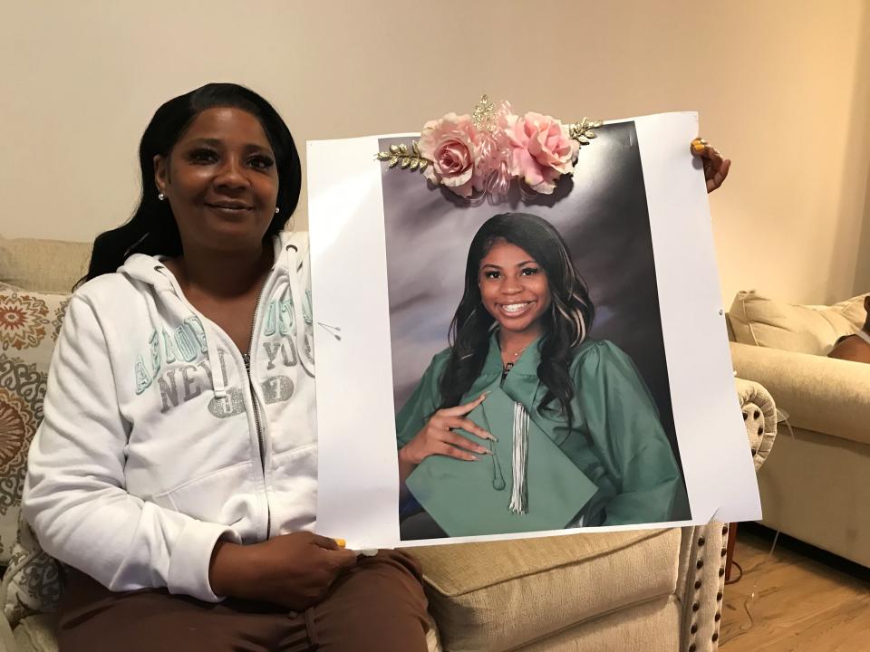 Latasha Reed holds a photo of her 15-year-old daughter, Monique Byrd, who was killed in a spray of gunfire outside a Paterson deli on May 11, 2022.