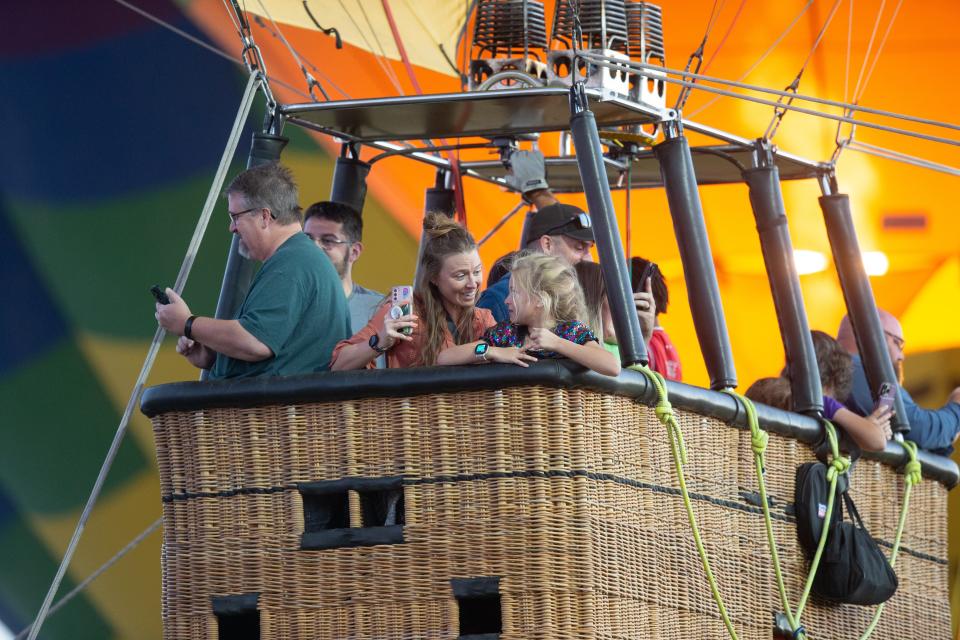 Festival guests ride a hot air balloon at the Spooktacular Hot Air Balloon Festival on Oct. 29, 2022, in Scottsdale.