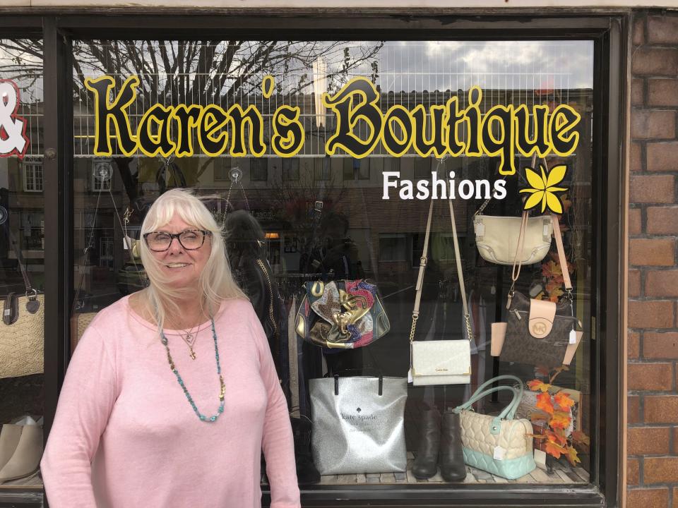 Karen Prohaska, 76, stands outside her purse and jewelry shop in downtown Plattsmouth, Nebraska, on Monday, Nov. 9, 2020. Prohaska says she hopes not to get the virus, but she usually doesn't wear a mask in her store because it hinders her breathing. She believes some people are overreacting to the threat. (AP Photo/Grant Schulte)