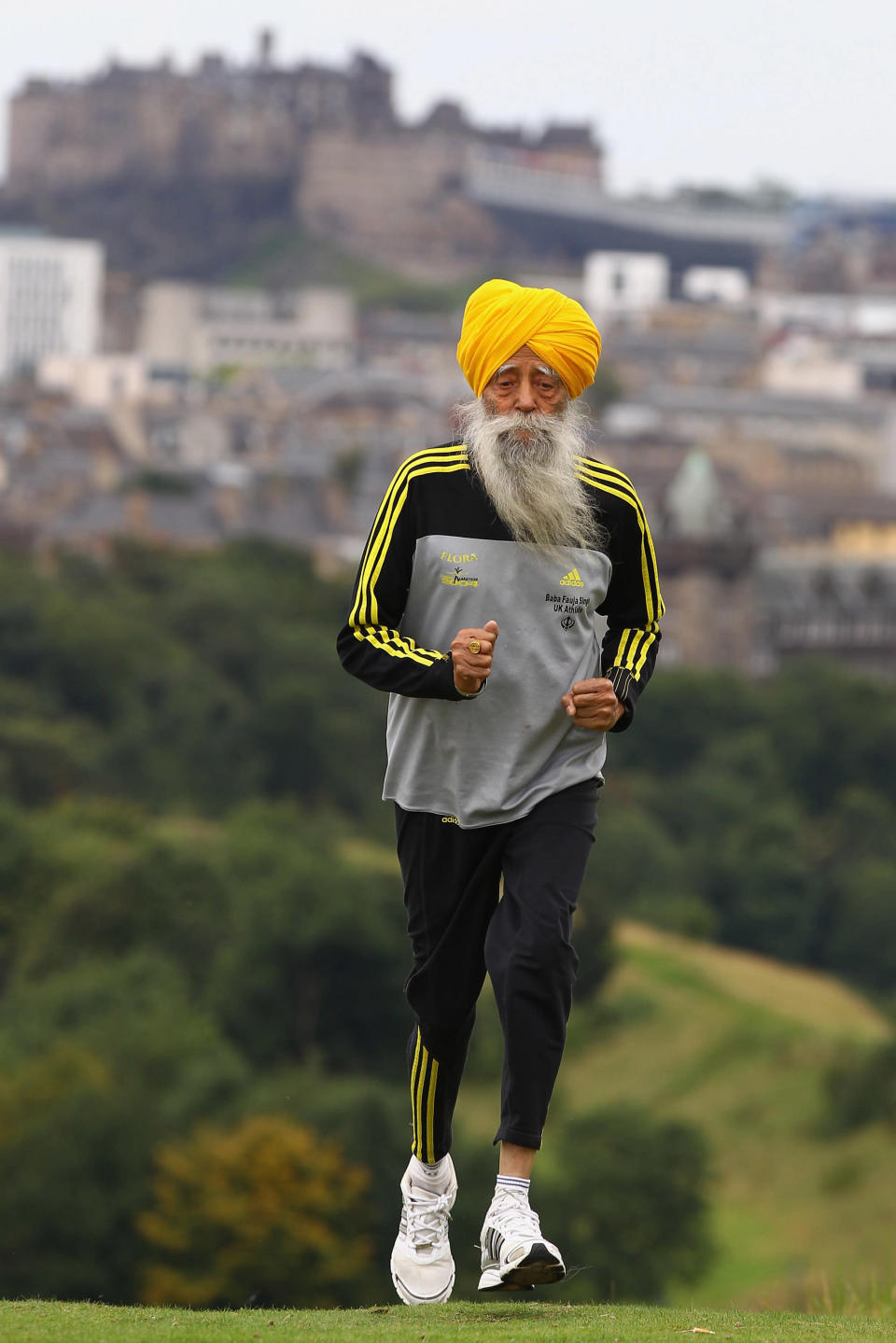 EDINBURGH, SCOTLAND - SEPTEMBER 01: Centenarian Sikh runner Fauja Singh poses for pictures after being the first person to officially enter for next year's Edinburgh Marathon on September 1, 2011 in Edinburgh, Scotland. A world record holder, aged 100, Fajua Singh has run seven marathons, all after his 89th birthday. He officially opened the entry process by signing up for his last ever 26 mile event in Edinburgh. (Photo by Jeff J Mitchell/Getty Images)