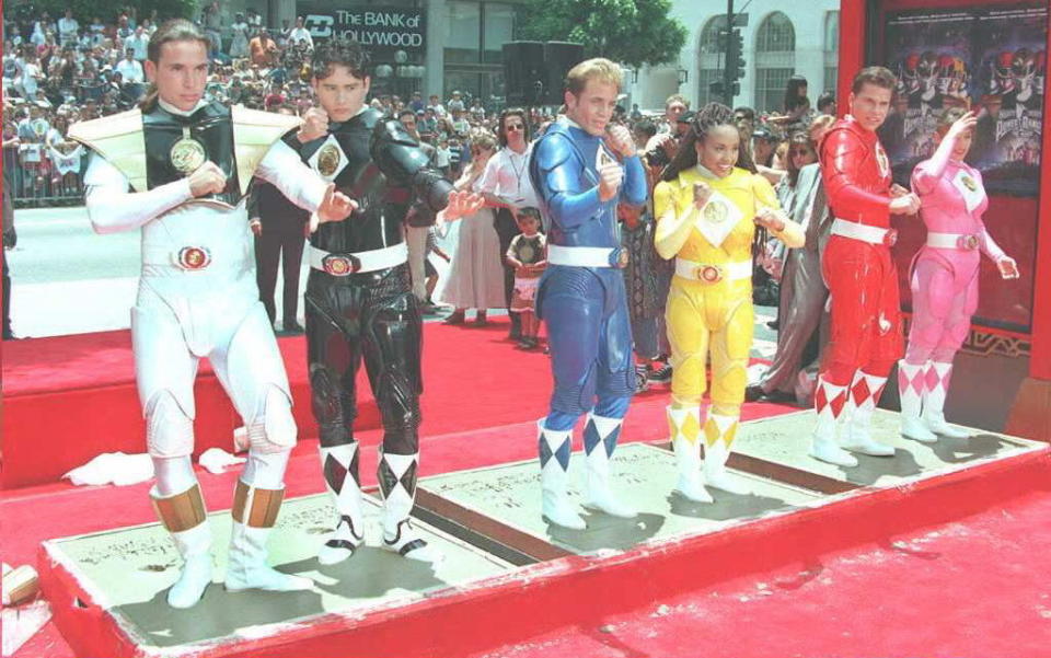 The Mighty Morphin Power Rangers strike poses as they stand in cement 22 June at Mann's Chinese Theater in Hollywood